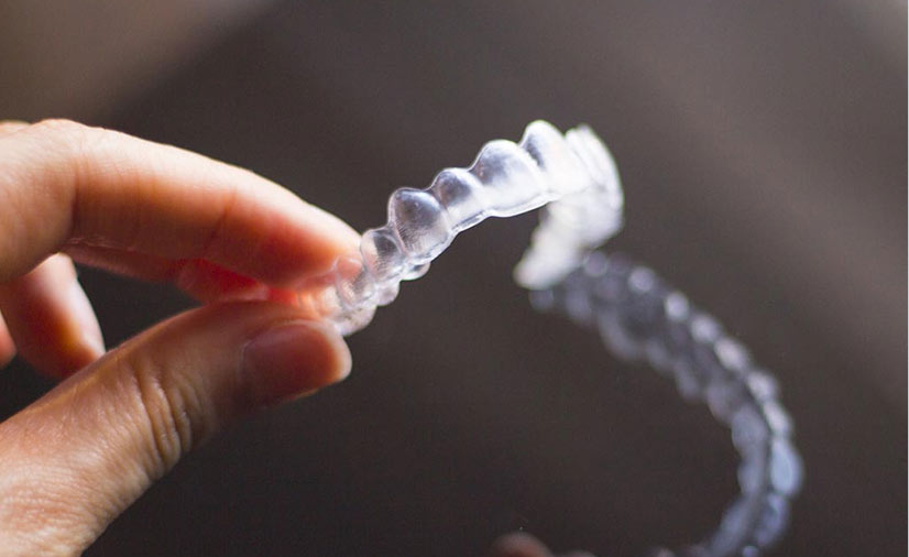 Person holding Invisalign Aligners in East London